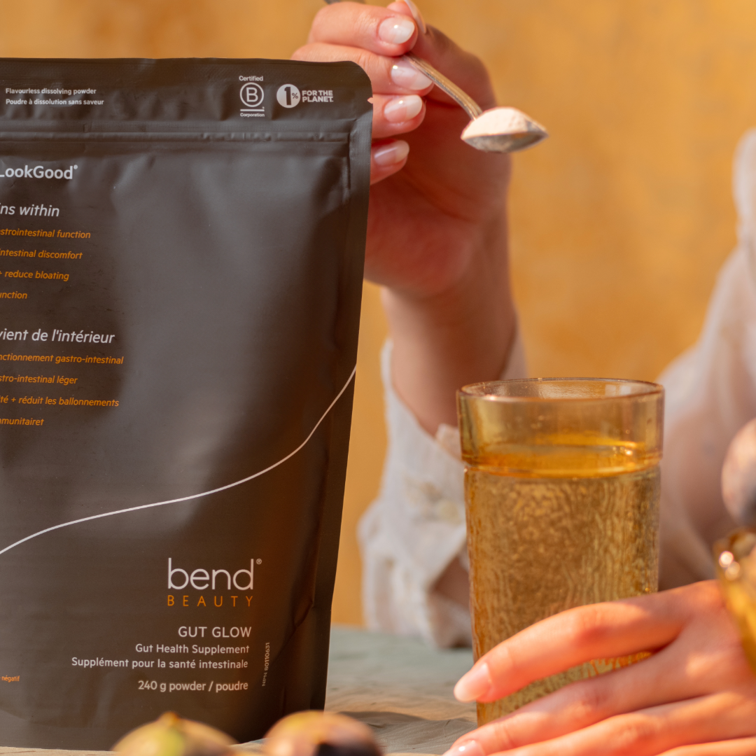 GUT GLOW pouch and spoon with powder mixing with water.